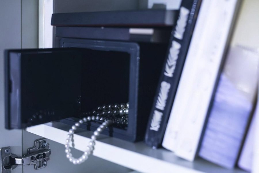 Small home jewellery safe on a shelf with a pearl necklace inside, illustrating storage options in Dubai